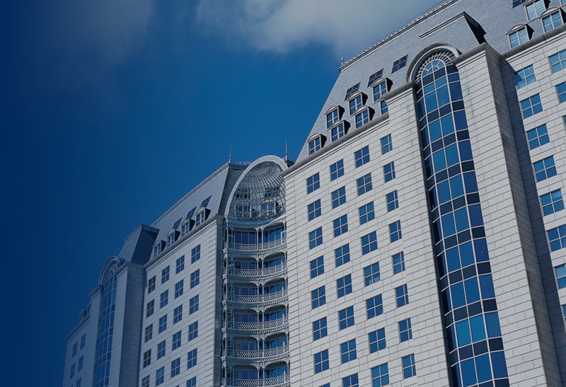 Big white Building and blue sky with white clouds.